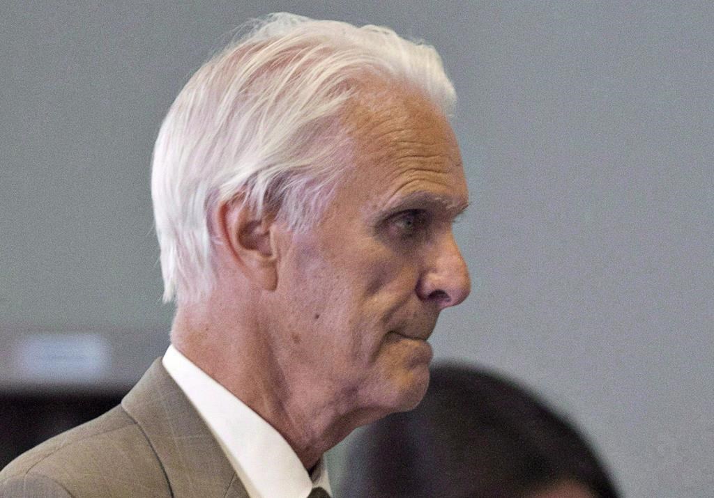 Former Quebec judge Jacques Delisle walks to court in Quebec City on June 14, 2012. A former Quebec judge found guilty in 2012 of fatally shooting his wife only to have that verdict overturned last year by the federal justice minister won't face a new trial. 