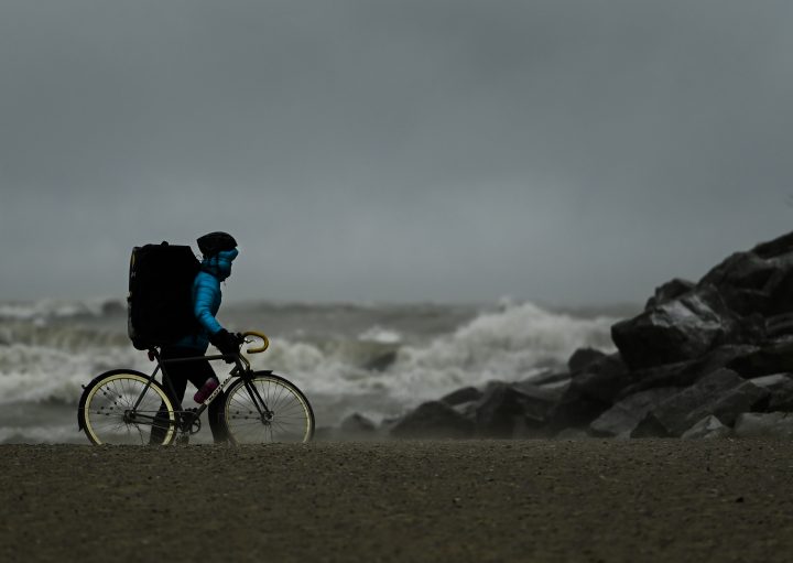 A person watches the waves roll in on Lake Ontario at Woodbine Beach on a windy day in Toronto on Wednesday, December 16, 2020.