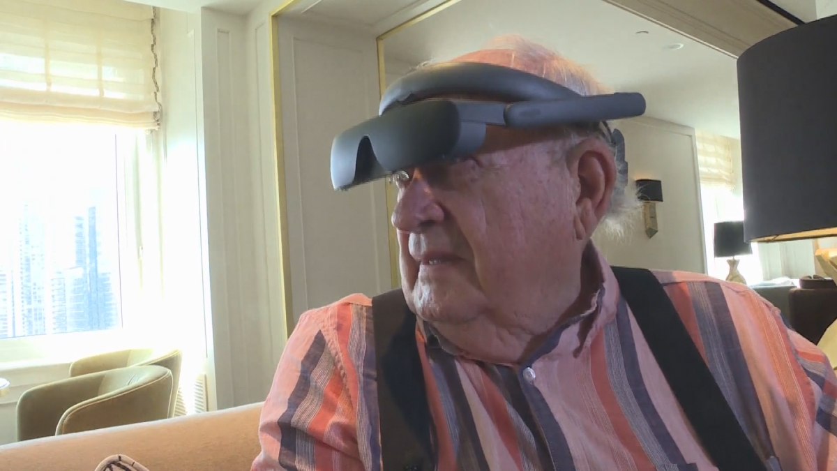 Eric MacDonald tries on his new pair of eSight glasses, gifted to him through not-for-profit charity We Are Young.