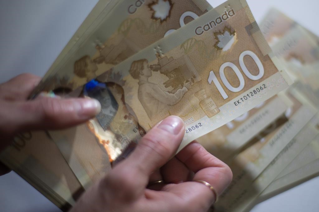 A file photo of Canadian $100 bills.