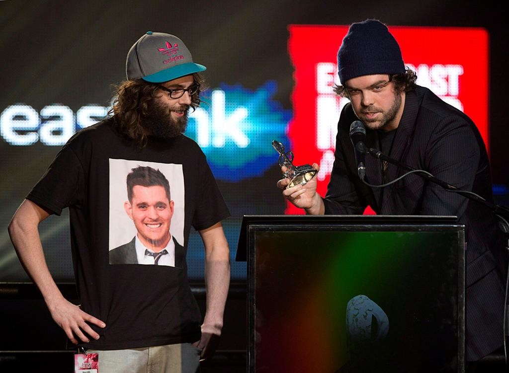 The Town Heroes, Bruce Gillis, left, and Mike Ryan receive the PEI 2014 fan's choice video of the year award for "New York City" at the East Coast Music Awards gala in Charlottetown on April 6, 2014. Events surrounding the 2022 East Coast Music Awards are set to get underway Wednesday in Fredericton, N.B. THE CANADIAN PRESS/Andrew Vaughan.