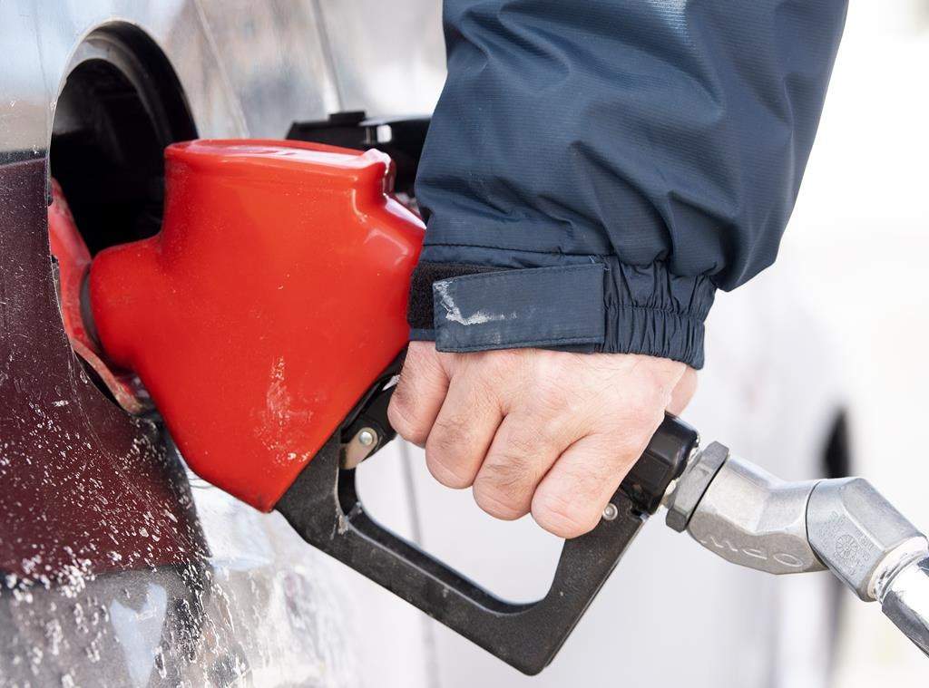 A man pumps gas in Montreal, Friday, March 4, 2022. National gas prices accelerated into staggering highs this month. THE CANADIAN PRESS/Graham Hughes.