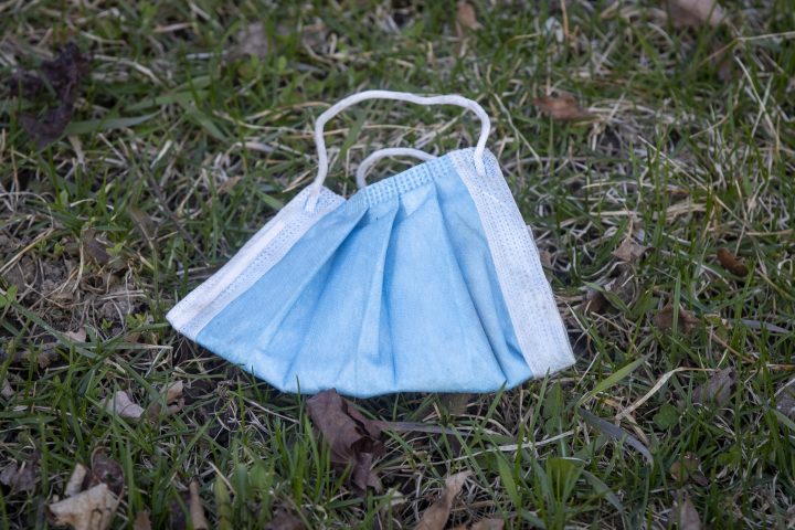A discarded surgical mask in a park, Tuesday April 12, 2022.