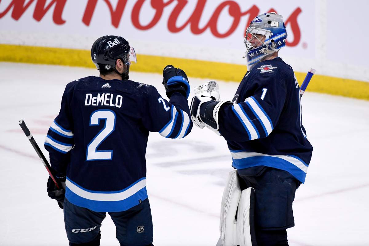Winnipeg Jets’ goaltender Eric Comrie (1) celebrates the win over the Seattle Kraken with Dylan DeMelo (2) during NHL action in Winnipeg on Sunday May 1, 2022.