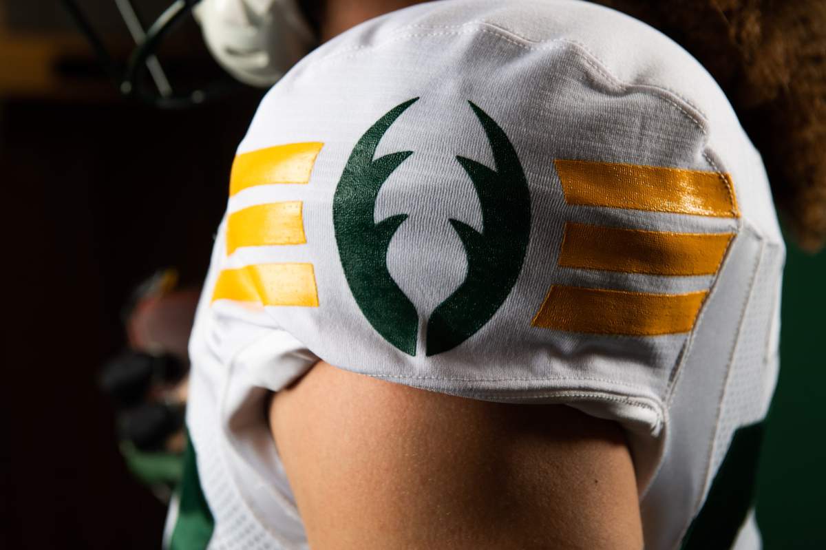 Edmonton Elks players in the team's new jerseys