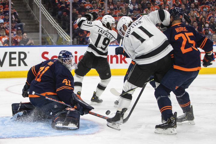 Los Angeles Kings’ Anze Kopitar (11) is stopped by Edmonton Oilers goalie Mike Smith (41) as Darnell Nurse (25) depends during first period NHL playoff action in Edmonton, Monday, May 2, 2022.