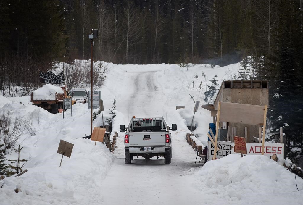 A Coastal GasLink contractor drives over a bridge on a remote logging road near Houston, B.C., on Thursday Jan. 17, 2019. THE CANADIAN PRESS/Darryl Dyck.