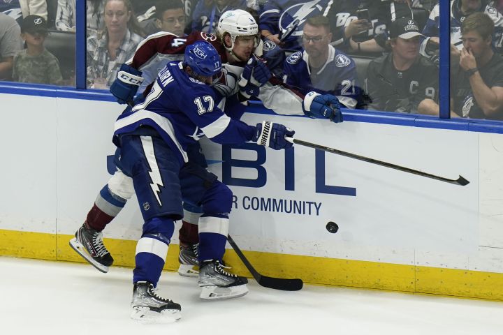 Tampa Bay Lightning left wing Alex Killorn (17) checks Colorado Avalanche defenceman Bowen Byram (4) during the third period of Game 3 of the NHL hockey Stanley Cup Final on Monday, June 20, 2022, in Tampa, Fla.