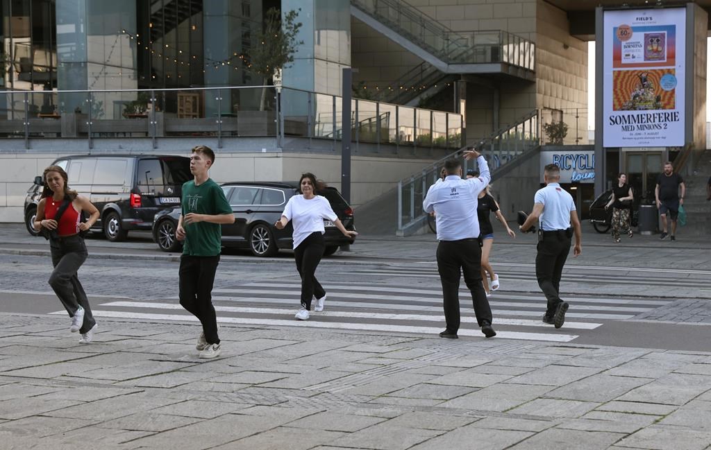 People evacuated from the Field’s shopping center run, in Orestad, Copenhagen, Denmark, Sunday, July 3, 2022, after reports of shots fired.