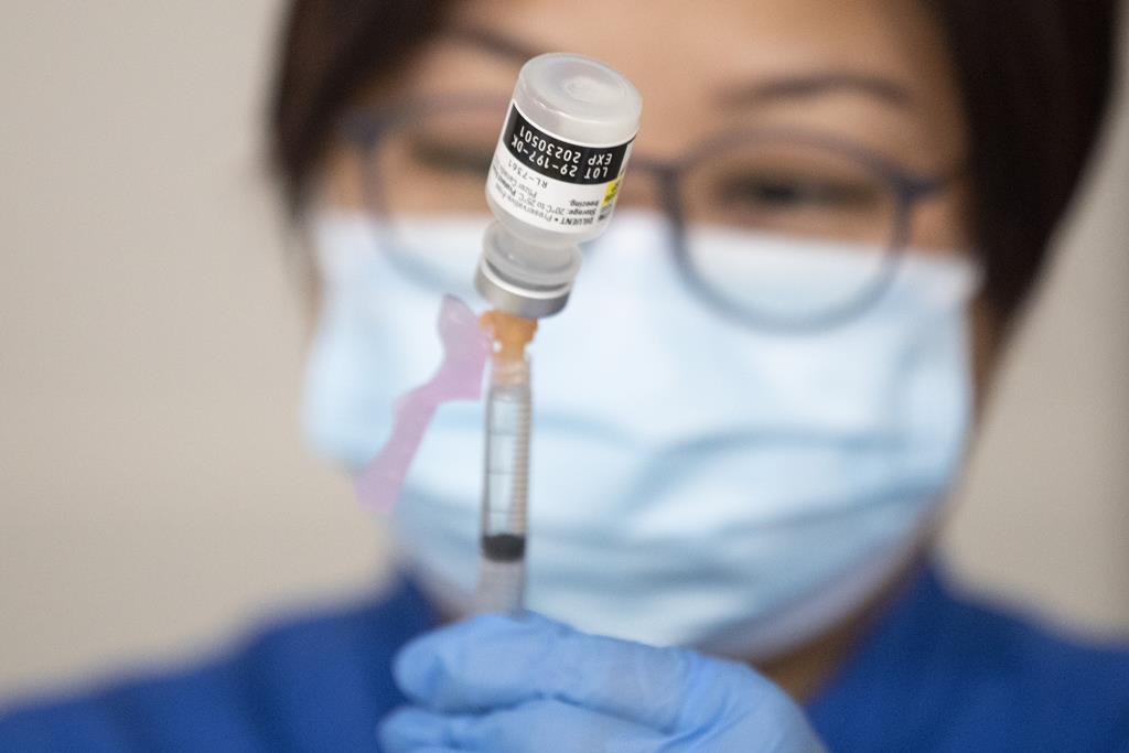 Nurse prepares COVID-19 vaccine