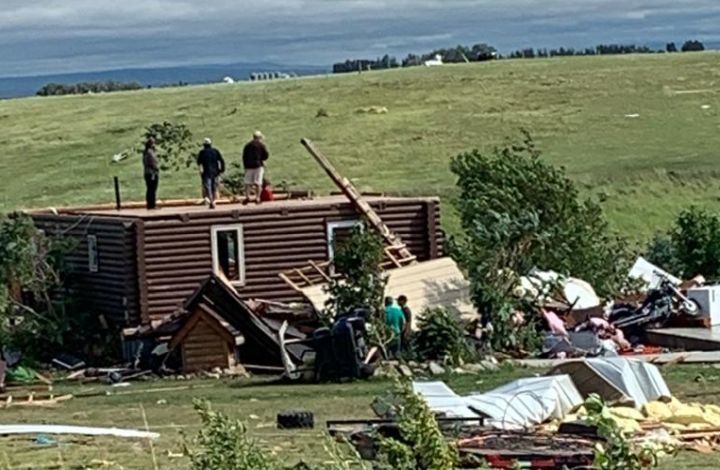 A photo of a log house west of Medicine Hat, Alta., on July 18, 2022. The home was missing its upper level after a storm tore through the area.