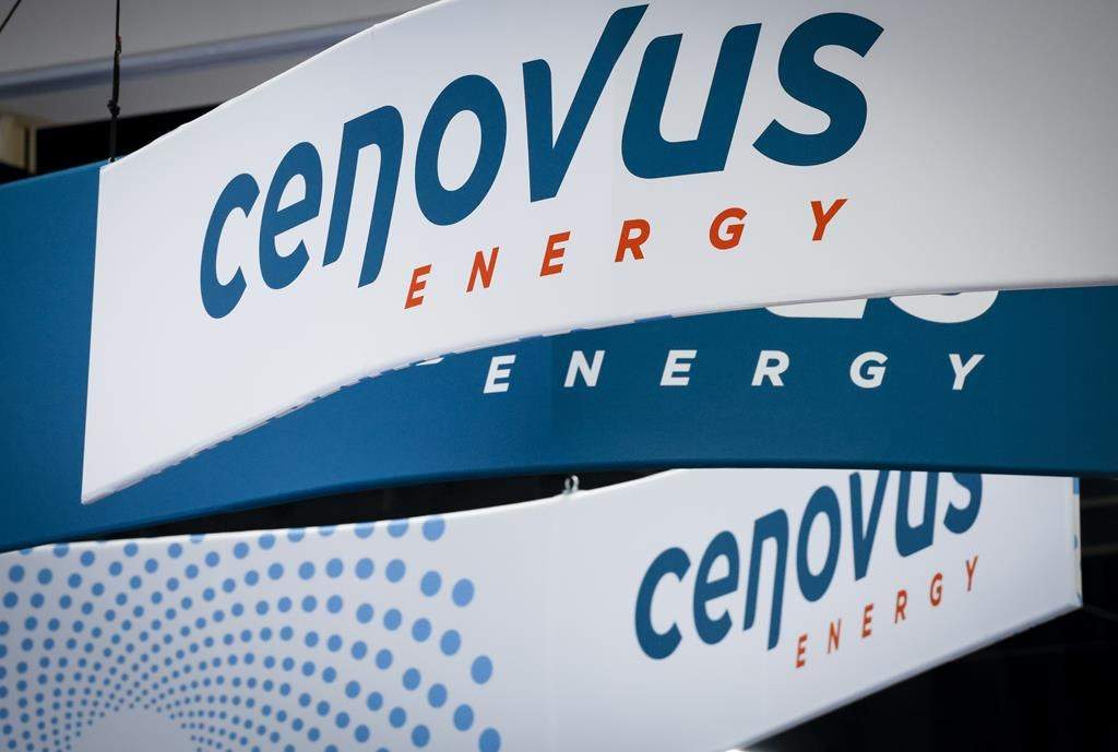 Cenovus Energy logos are on display at the Global Energy Show in Calgary, Alta., Tuesday, June 7, 2022. Cenovus Energy Inc. has reached a deal with British energy giant BP to buy the remaining 50 per cent stake in the BP-Husky Toledo Refinery for $300 million.