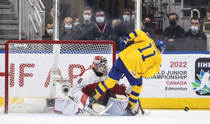 Sweden’s Fabian Lysell (11) is stopped by Austria’s goalie Sebastian Wraneschitz (30) on a penalty shot during third period IIHF World Junior Hockey Championship action in Edmonton on Friday August 12, 2022.