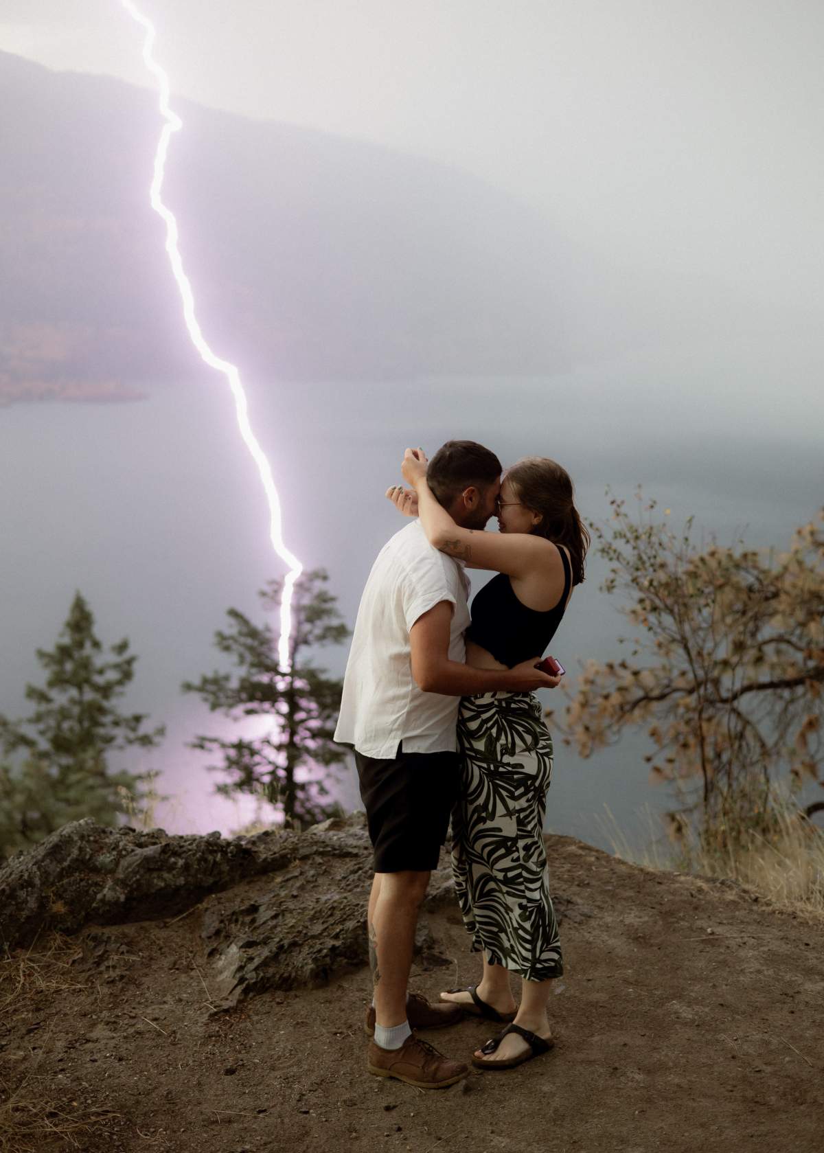 Alisa Hemming and her now fiancé, Liam Duncan embrace in a traditional engagement photo pose.