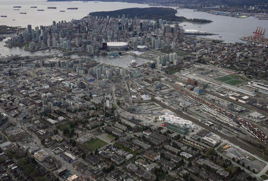 The downtown Vancouver skyline is seen in an aerial view from east Vancouver, on Saturday, April 9, 2022. The City of Vancouver says none of the municipal election candidates named in a court action by its chief election officer will be disqualified from running, regardless of whether a judge agrees to remove names in non-Latin characters from ballots. THE CANADIAN PRESS/Darryl Dyck.