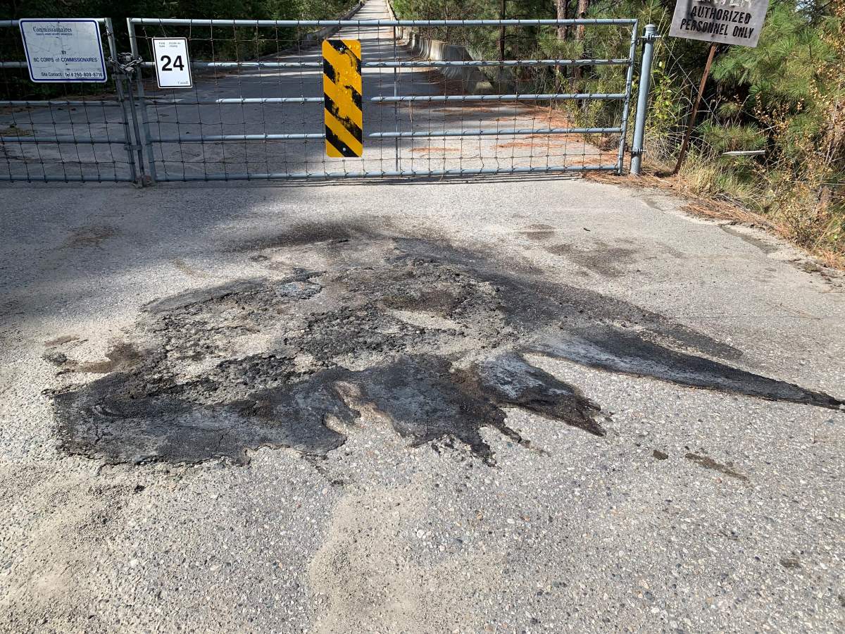 A photo showing a large burn spot on a frontage road, south of Summerland, beside Highway 97.