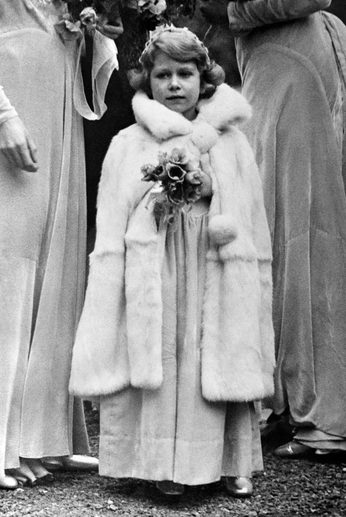 Princess Elizabeth arrives at the 16th Century Church at Balcombe, Sussex, for the wedding of Lady May Cambridge and Captain Henry Abel Smith in 1931.