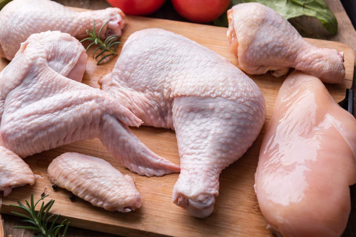 Raw chicken portions on a cutting board.
