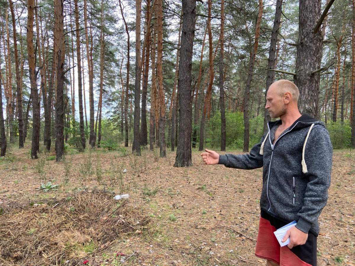 Oleksii Sukhorebryi shows the site where his nephew was found executed by Russian soldiers in Dibrova, Ukraine.