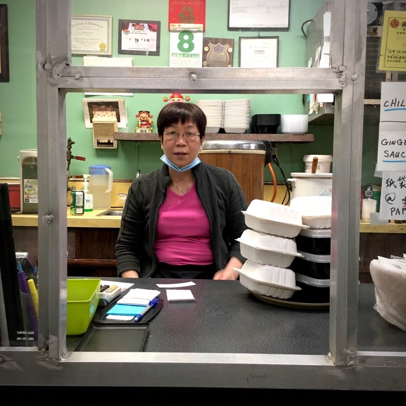 Tracy Li working the front counter of Gain Wah restaurant on the night before the September 9, 2022 fire.