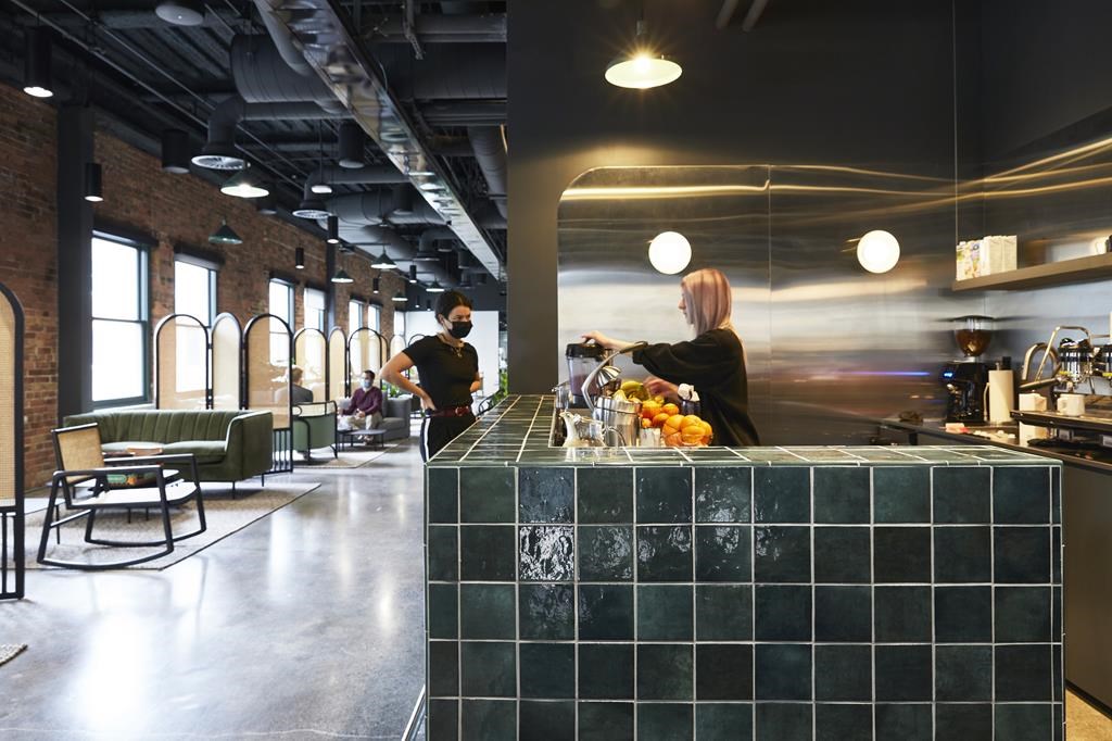 Workers are seen around a cafe-style bar in Lightspeed’s Montreal office in an undated handout photo. 