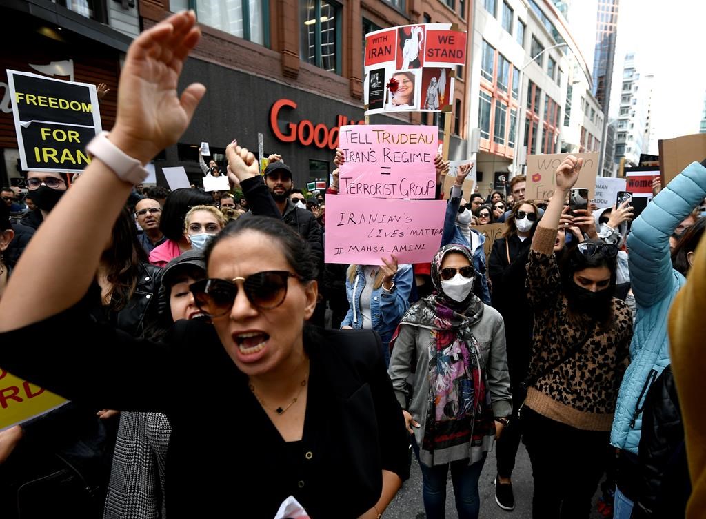 Members of the Iranian community and their supporters rally in solidarity with protesters in Iran, after 22-year-old Mahsa Amini died in police custody for allegedly improperly wearing a hijab, in Ottawa on Sunday, Sept. 25, 2022. THE CANADIAN PRESS/Justin Tang