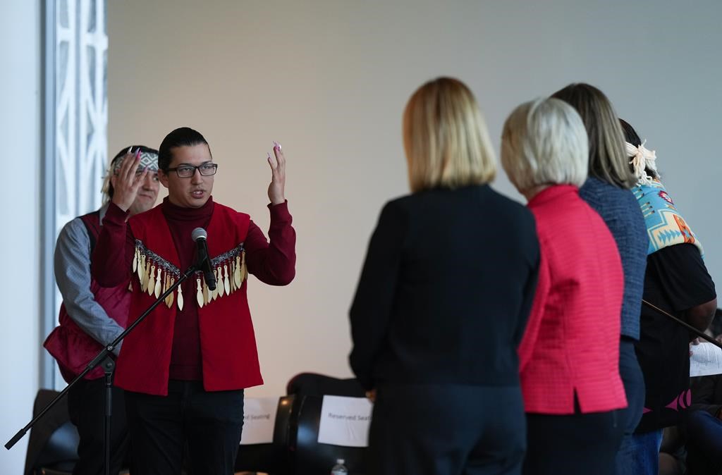 Squamish Nation councillor Khelsilem, left, addresses city councillors after presenting them with a copy of the United Nations Declaration on the Rights of Indigenous Peoples (UNDRIP) task force report, in Vancouver, on Wednesday, October 19, 2022. The final report is a result of a partnership with the Musqueam Indian Band, Squamish Nation and Tsleil-Waututh Nation. According to the task force it is the first co-developed strategy between Indigenous nations and a municipal government in Canada. 