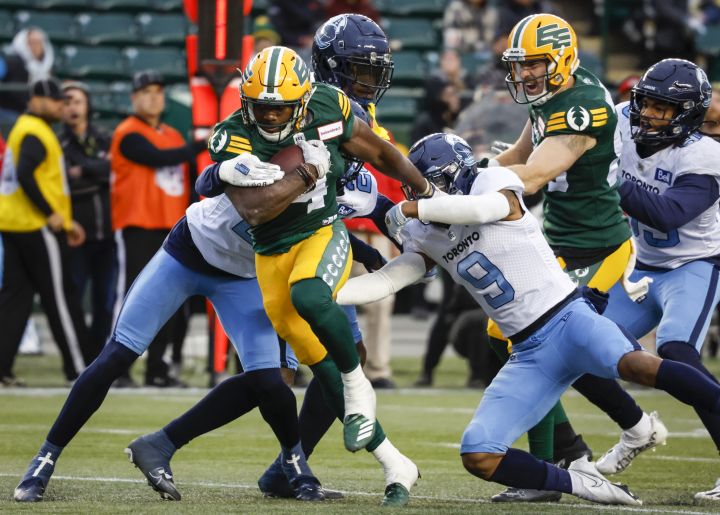 Toronto Argonauts’ Royce Metchie, right, lets Edmonton Elks’ Kevin Brown escape his grasp during first half CFL football action in Edmonton, Saturday, Oct. 15, 2022.