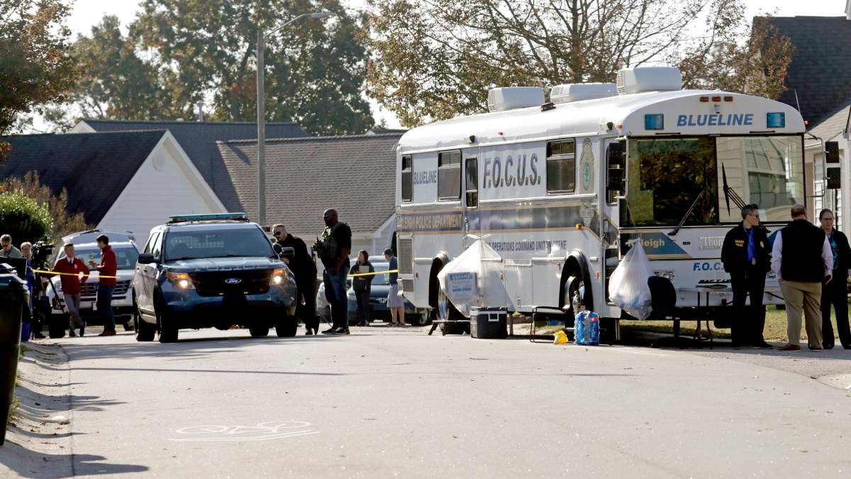 Police remain on the scene at Castle Pines Dr. and Sahalee Way following a shooting Thursday night in Raleigh, N.C., on Friday, Oct. 14, 2022. Police say a 15-year-old boy fatally shot at least two people in the streets of a neighborhood in North Carolina’s capital city, then fled toward a walking trail, where he opened fire, killing and wounding others.