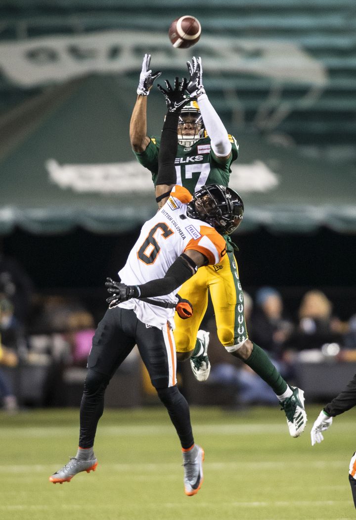 B.C. Lions’ T.J. Lee (6) and Edmonton Elks’ Dillon Mitchell (17) vie for the ball in the air during first half CFL action in Edmonton, Alta., on Friday October 21, 2022.