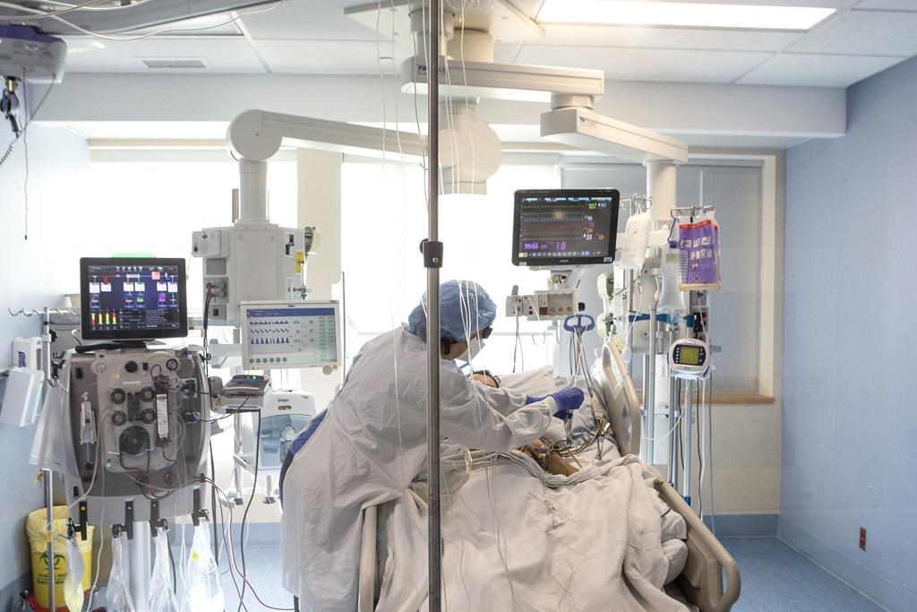 A nurse tends to a patient in the Intensive Care Unit at the Bluewater Health Hospital in Sarnia, Ont., on Tuesday, January 25, 2022. Personal support workers in Ontario hospitals were promised last spring that a wage increase introduced during the pandemic would remain permanently on their paycheques. THE CANADIAN PRESS/Chris Young.