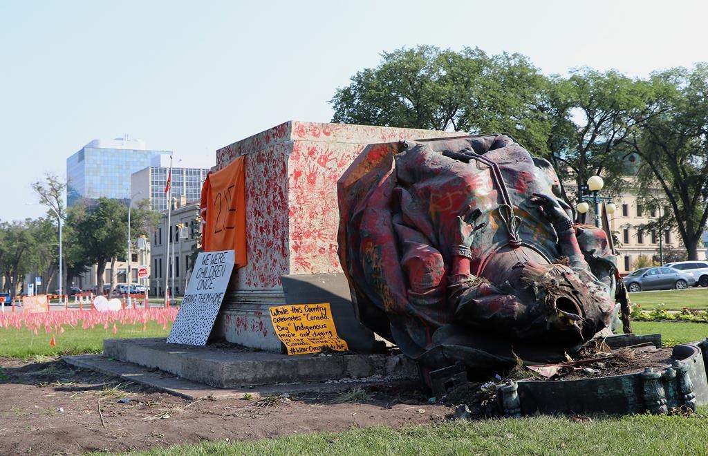A headless statue of Queen Victoria is seen overturned and vandalized at the Manitoba legislature in Winnipeg on July 2, 2021. The last remnant of the s being cleared away in the coming days, more than a year after it was toppled. 
