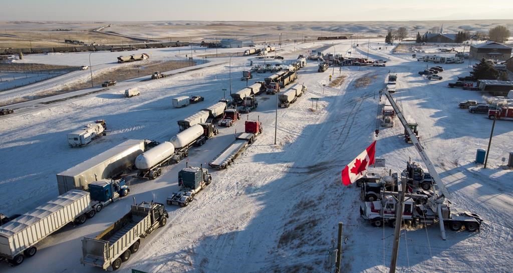 A truck convoy of anti-COVID-19 vaccine mandate demonstrators  block the highway at the busy U.S. border crossing in Coutts, Alta., on February 2, 2022. 