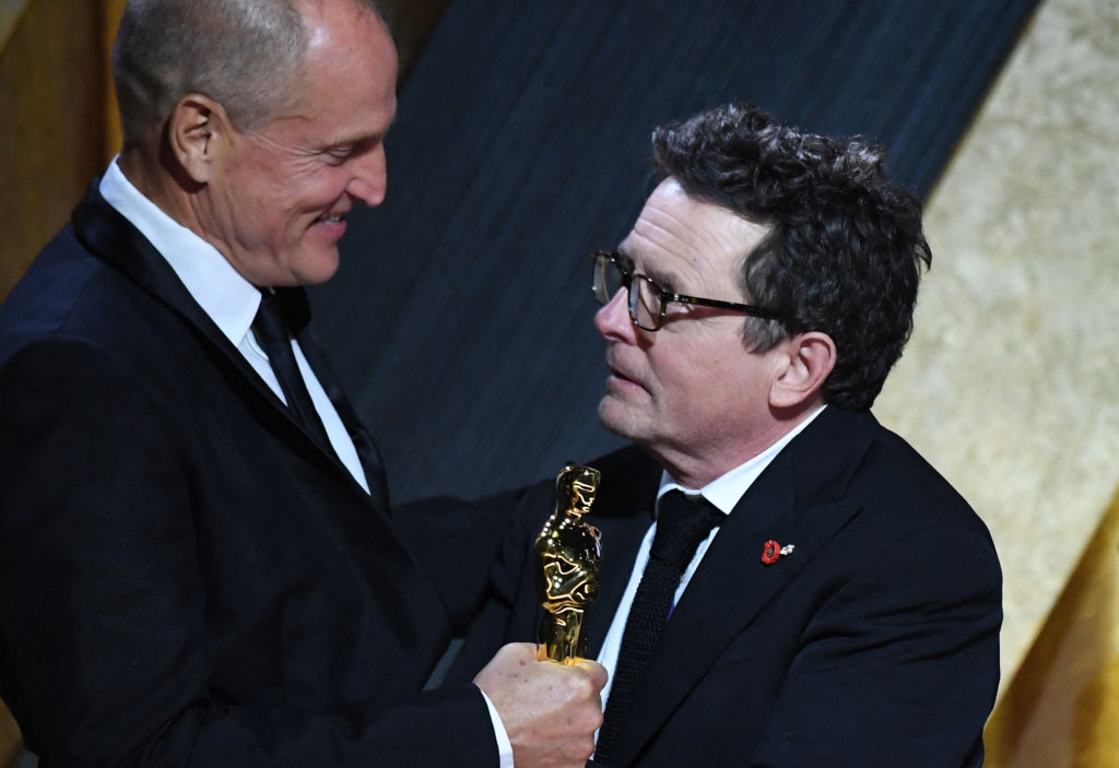 Honoree Canadian-American actor Michael J. Fox (R) accepts the Jean Hersholt Humanitarian Award from U.S. actor Woody Harrelson during the Academy of Motion Picture Arts and Sciences’ 13th Annual Governors Awards at the Fairmont Century Plaza in Los Angeles on Nov. 19, 2022.