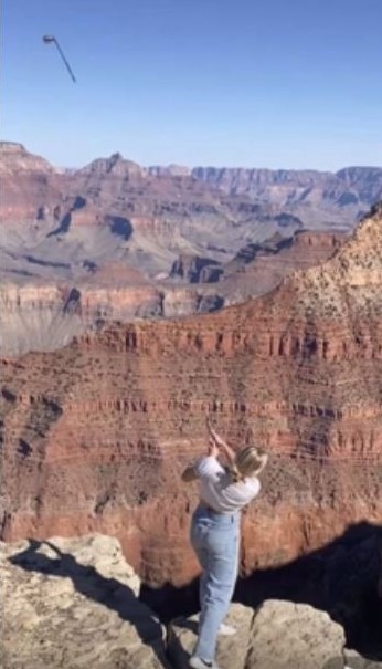 A screenshot of the woman's golf club mid-air.