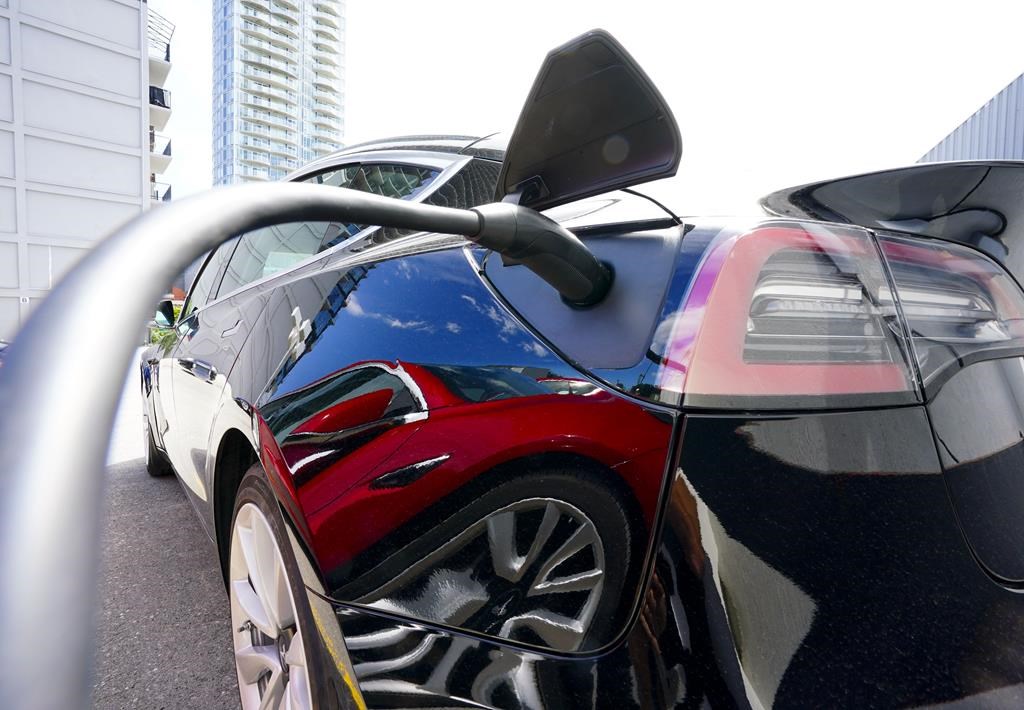An electric vehicle is charged in Ottawa on Wednesday, July 13, 2022.