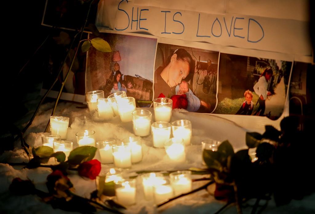 A vigil with photos of Morgan Harris attached is shown as family and friends of three murdered women gather at a vigil in Winnipeg.