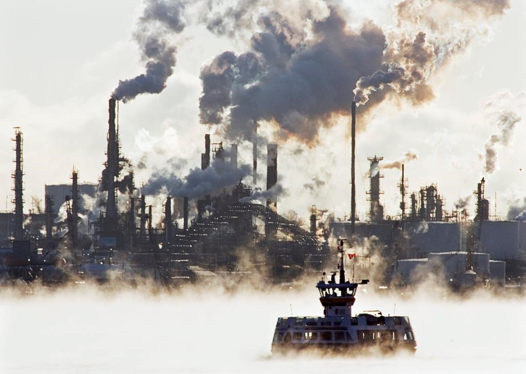 A passenger ferry crosses Halifax harbour through sea smoke in front of Imperial Oil's Dartmouth refinery on Thursday, Jan. 3, 2008.