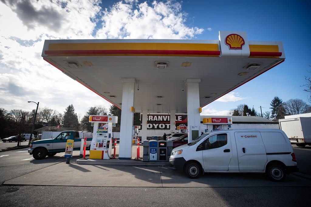 Motorists fuel up vehicles at a Shell gas station in Vancouver, on Tuesday, March 8, 2022. Shell Canada says its purchase of 56 gas stations from the parent company of Sobeys is part of Shell's long-term plan to grow its network of retail fuel stations.