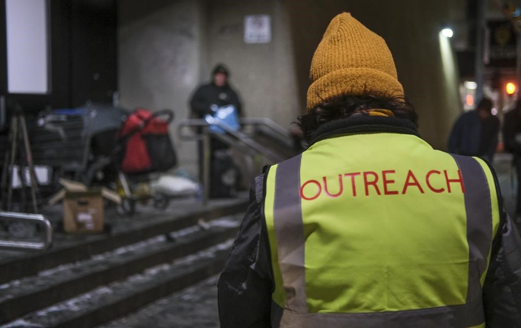 Outreach volunteers offer help to the homeless on a -20 C night in Calgary, Alta., Tuesday, Dec. 14, 2021.