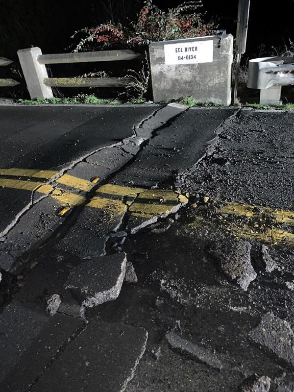 This image posted by Caltrans District 1 shows a road closure on California State Route 211 at Fernbridge, a 1,320-foot-long (402.3 m) concrete arch bridge that spans the Eel River near Fortuna, Calif., in Humboldt County. The bridge is closed while they conduct a safety inspection checking for possible seismic damage. Officials say a strong earthquake in Northern California has cut off power to thousands and damaged roads and homes. No injuries have been reported in the magnitude 6.4 earthquake early Tuesday near Ferndale. That’s a small community over 200 miles northwest of San Francisco and close to the Pacific Coast. (Caltrans District 1 via AP)