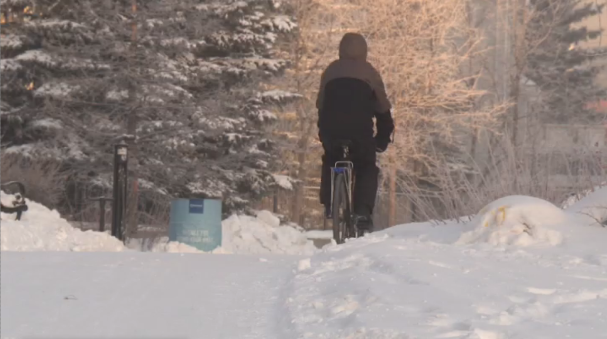 A cyclist uses a multi-use path, separated from car traffic, in Edmonton in Jan. 2021.