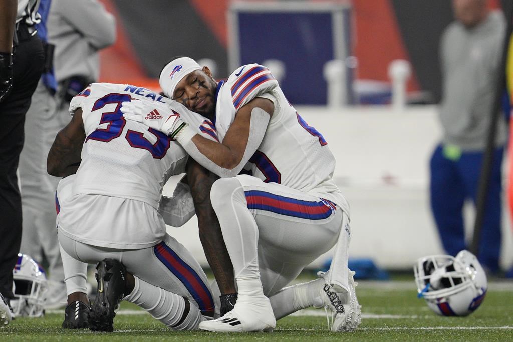 Buffalo Bills’ Siran Neal (33) and Nyheim Hines react after teammate Damar Hamlin was injured during the first half of an NFL football game against the Cincinnati Bengals on Jan. 2 in Cincinnati.