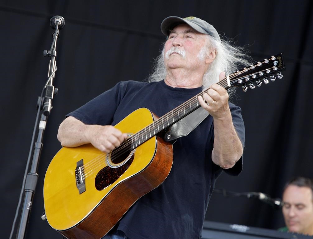 David Crosby holding a guitar.