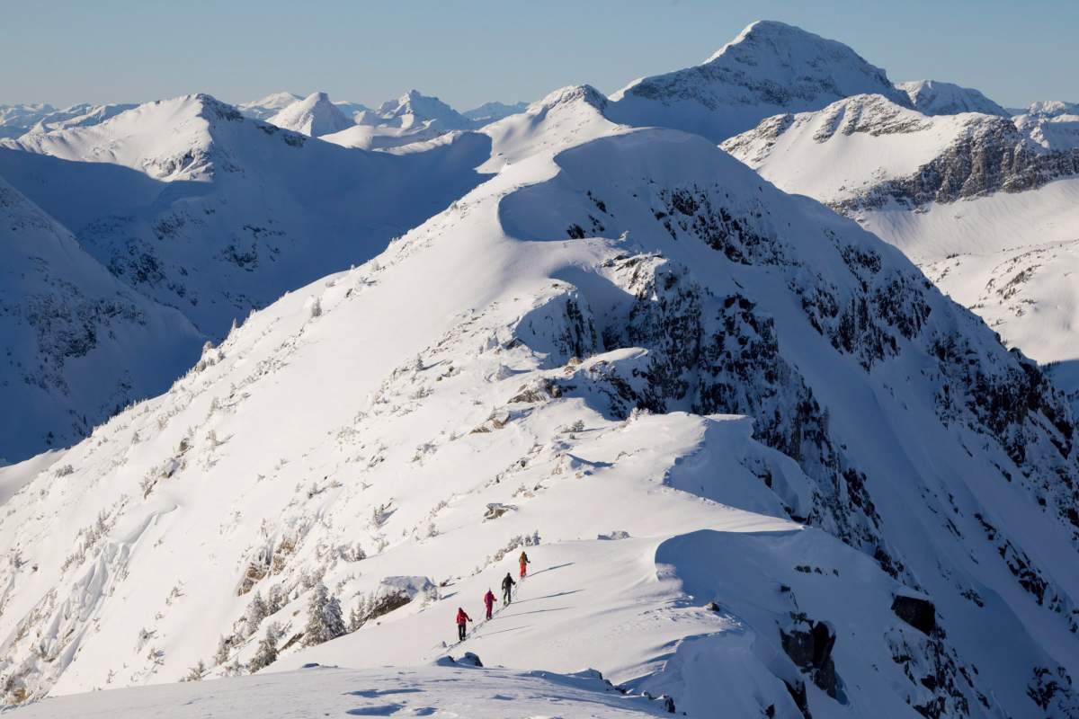 Backcountry skiers are dwarfed by the mountains as they make their way along a mountain ridge near McGillivray Pass Lodge located in the southern Chilcotin Mountains of British Columbia, Tuesday, Jan. 10, 2012. Five people have been killed in British Columbia avalanches this month. Forecasters have compared this season’s snowpack with the conditions of the 2003, one of the worst years on record for fatalities. 