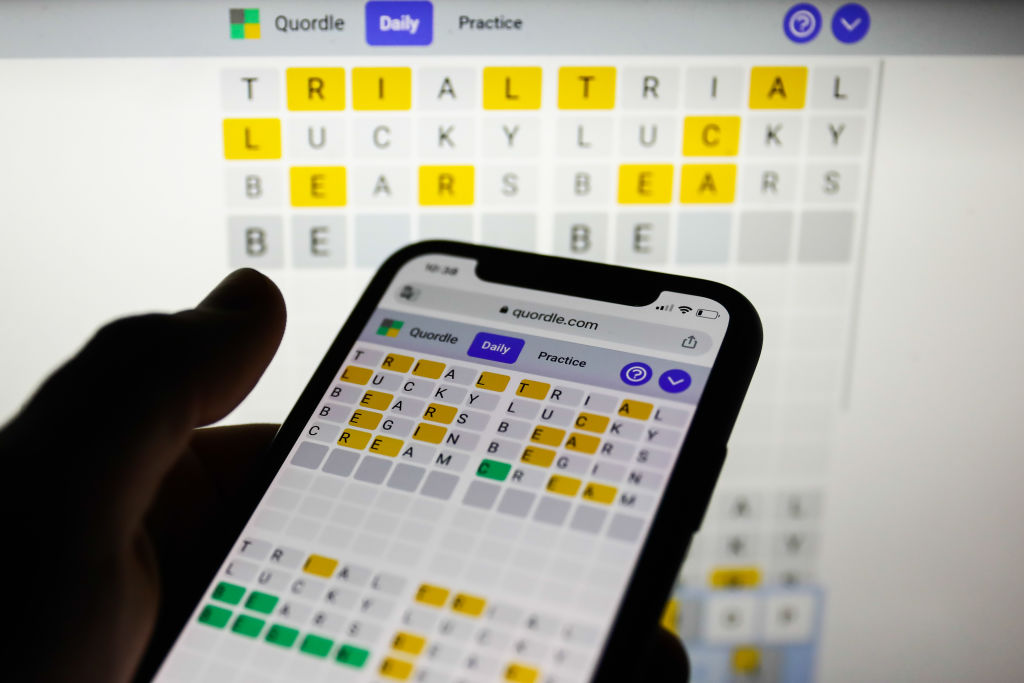 File - Quordle game displayed on a phone and a laptop screen, seen in this illustration photo taken on February 21, 2022.