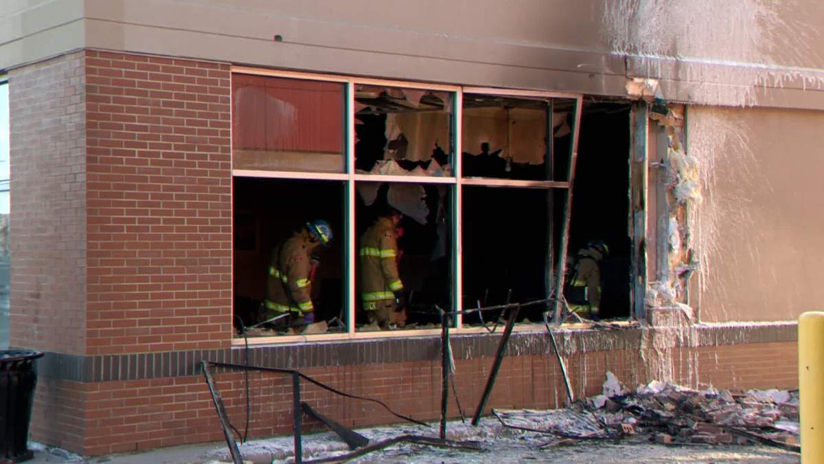 Investigators comb through evidence of a fire at a Calgary restaurant on Jan. 5, 2023.