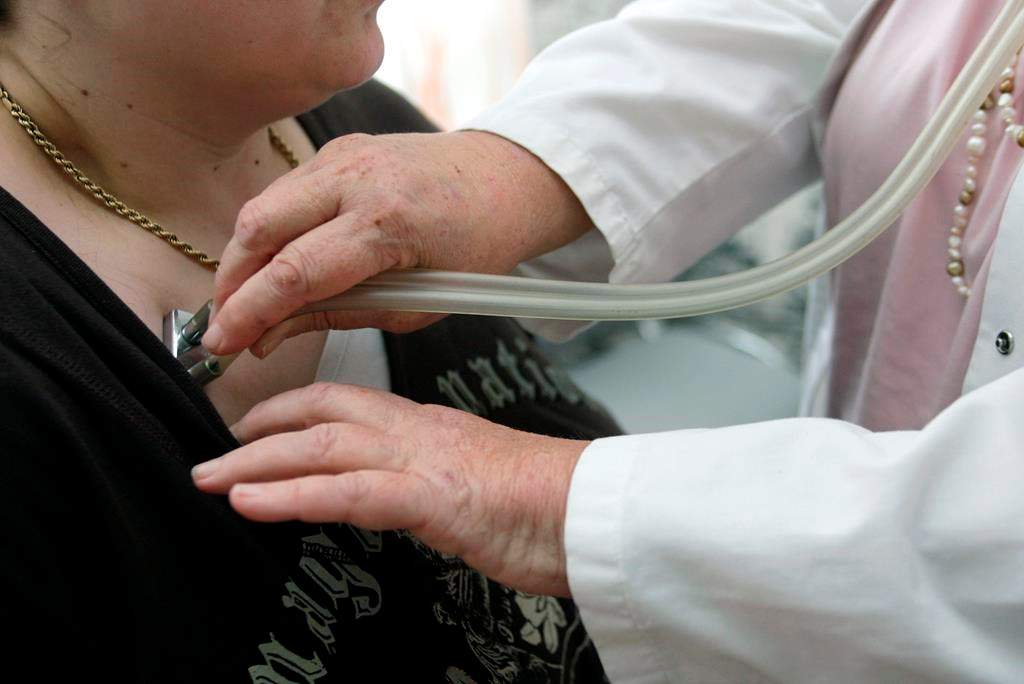 A doctor examines a patient with a stethoscope in her doctor's office in Stuttgart, Germany, on Monday, April 28, 2008.