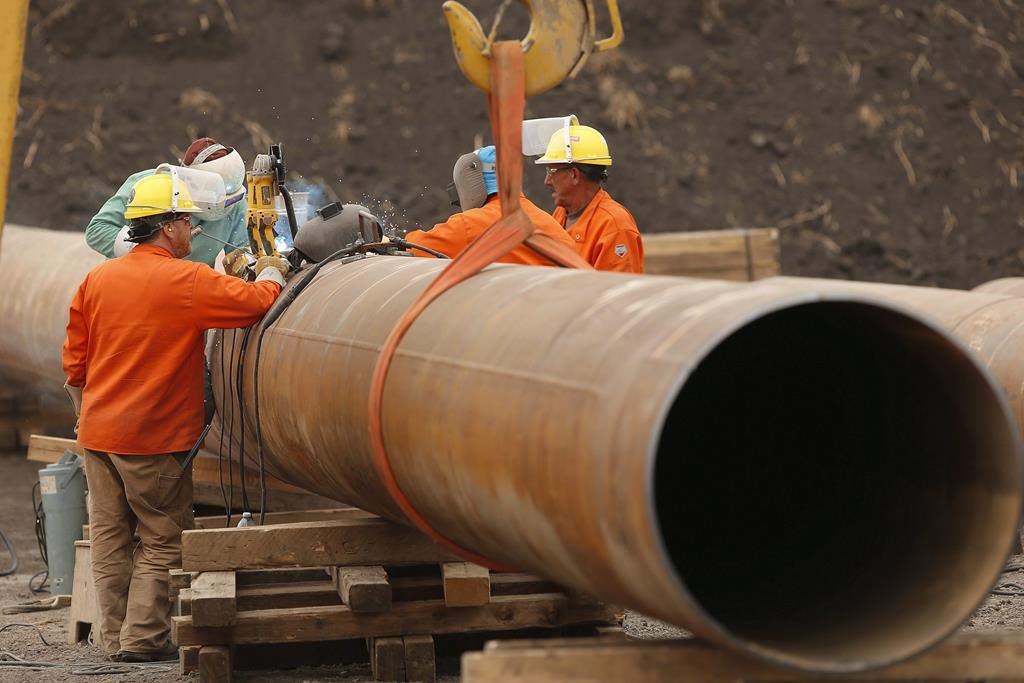 The new CEO of pipeline giant Enbridge Inc. says regulatory uncertainty in this country has resulted in a "lost decade" for Canadian LNG production. Enbridge workers weld pipe just west of Morden, Man., Thursday, Aug. 16, 2018. THE CANADIAN PRESS/John Woods.