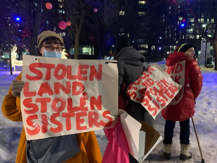 Supporters at a MMIWT2S+ rally in Montreal carry signs that read” Stolen land, stolen sisters.” Tuesday, Feb. 14, 2023.